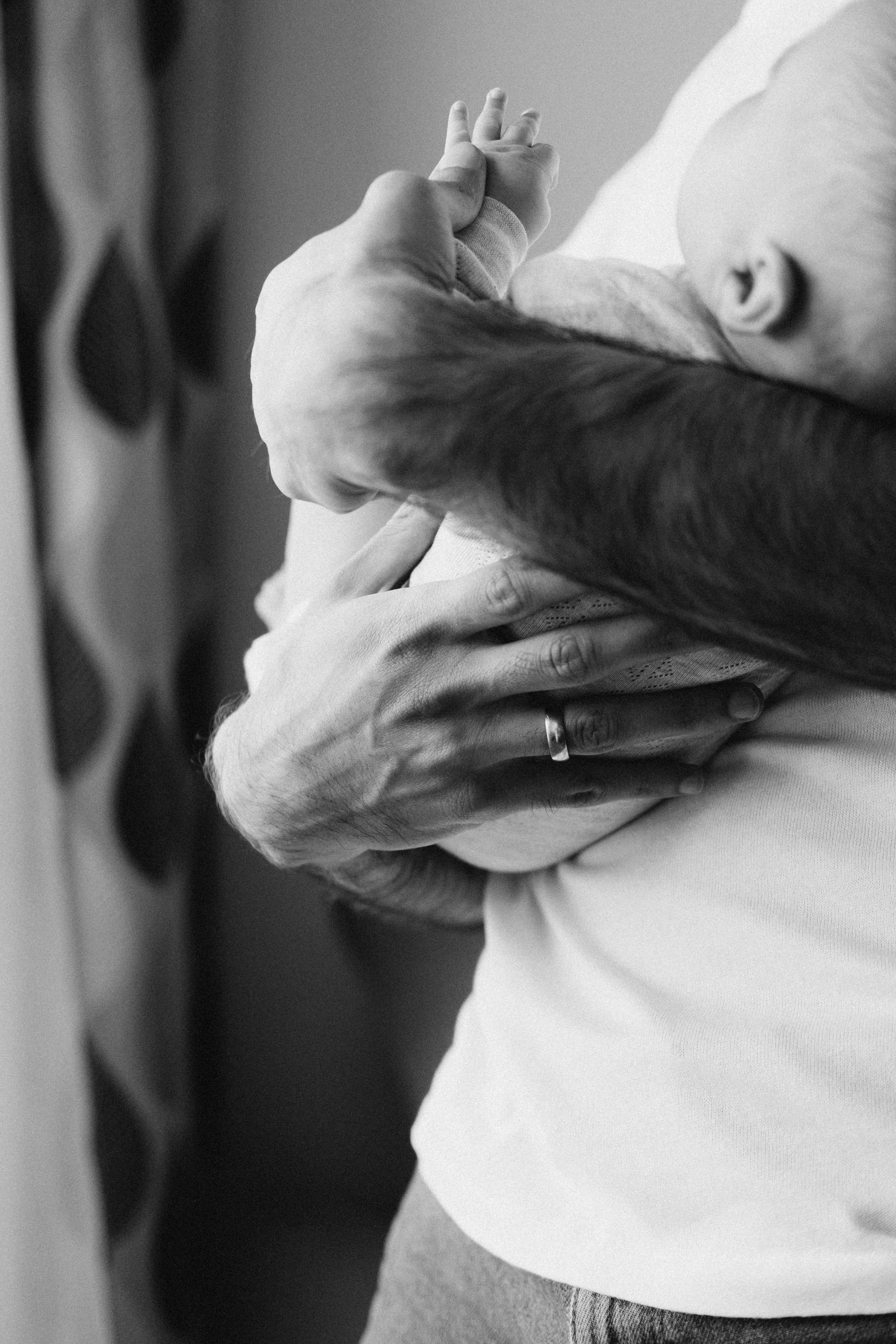 grayscale photo of person wearing ring